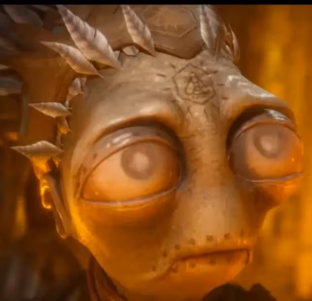 Her eyes seem to be blind from cataracts. Also, her mouth and eyelids have marks. I am not sure whether these were painted here or are marks of her own stitches. It would make sense that she's blind, if she used to be a blinded Mudokon